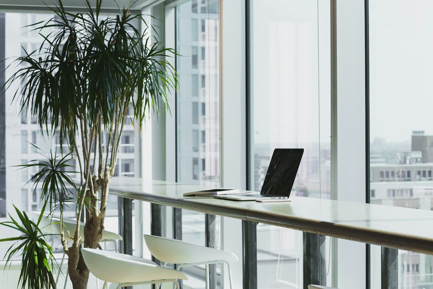 Bright modern office workspace with a city view through floor-to-ceiling windows