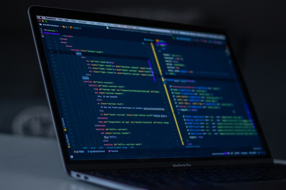 Laptop screen showing source code in a dark editor